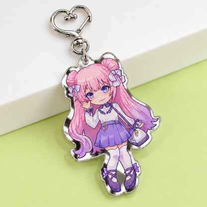 Anime chibi girl mirror acrylic keychain displayed on light green table, custom printed die cut mirror acrylic charm