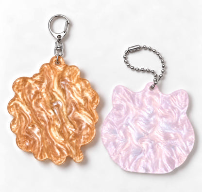 Rear view of mica acrylic keychains, golden and pink swirl texture, cute decor to hang on bags