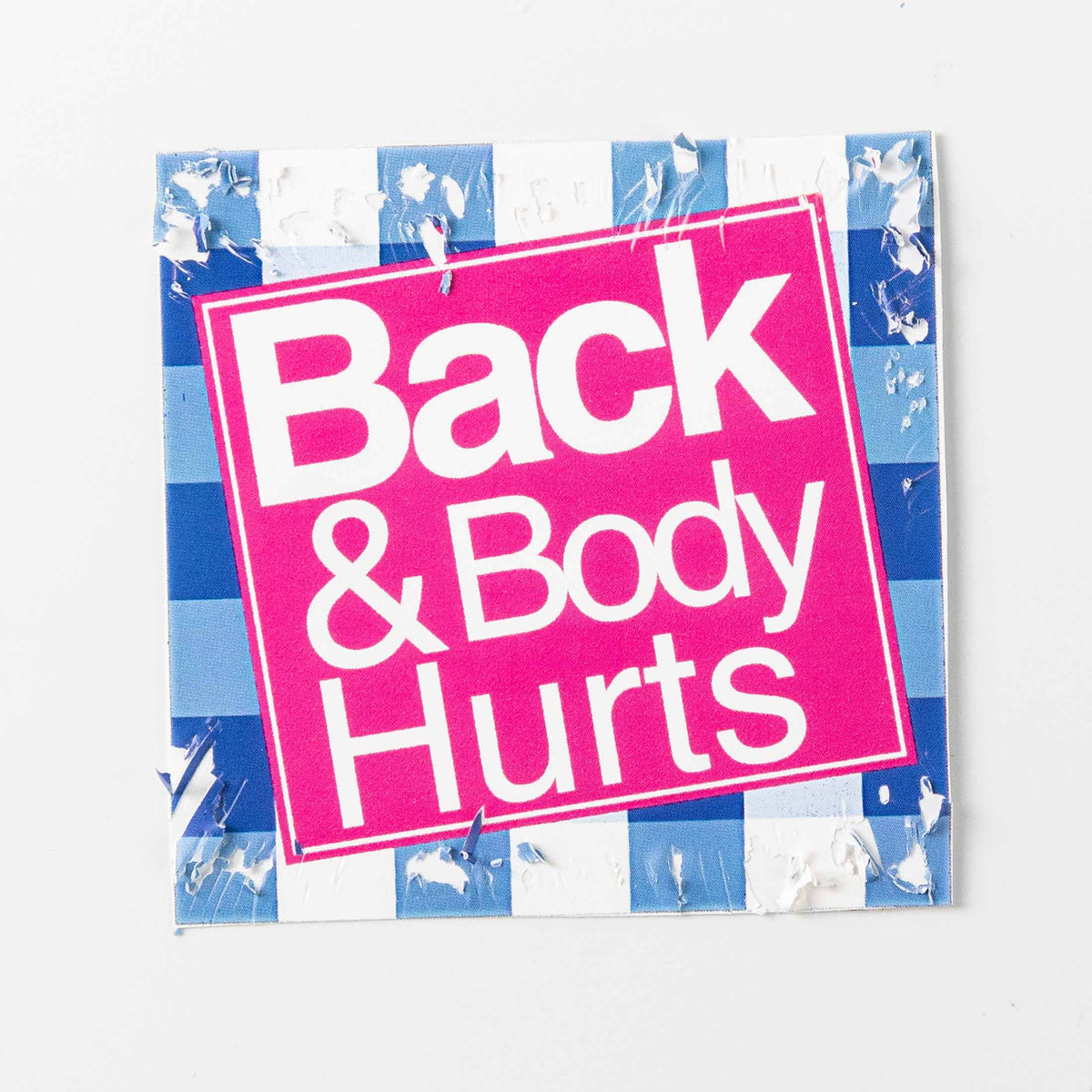 Fragile square sticker; features pink color blocks against a blue grid background, with a cracked surface texture.