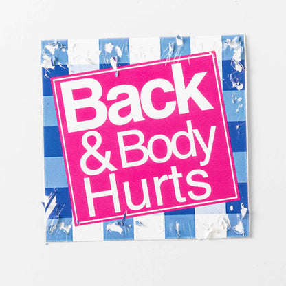 Fragile square sticker; features pink color blocks against a blue grid background, with a cracked surface texture.