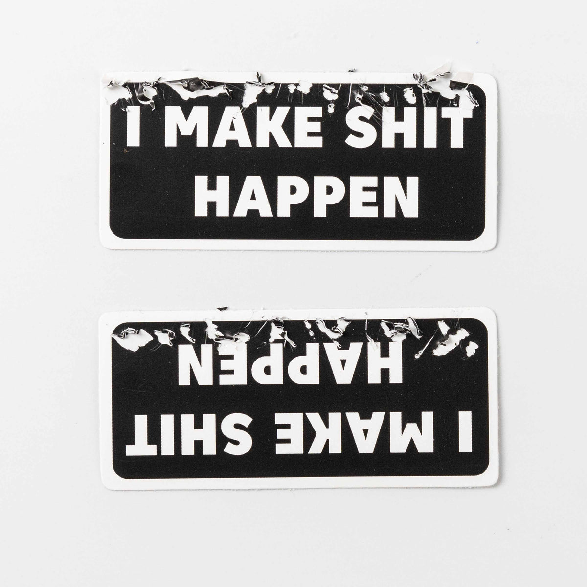 Two rounded rectangle fragile stickers, black white text, torn peeling edge, one mirrored sticker