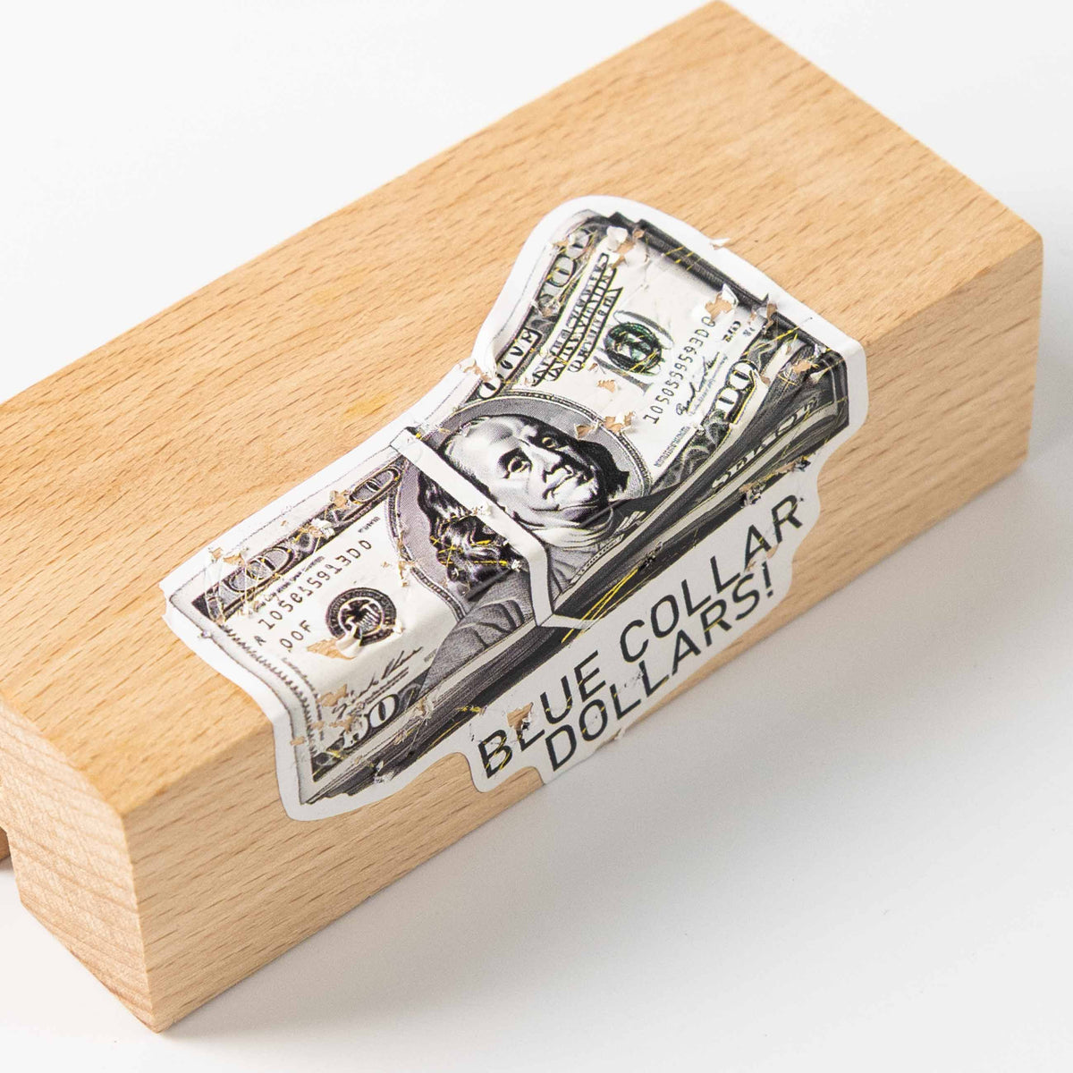 Banknote shaped fragile sticker, torn peeling texture, placed on light wood block