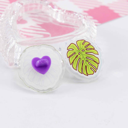 Close-up of a custom transparent acrylic badge: showcasing the details of a cute brooch with a heart-shaped clasp.