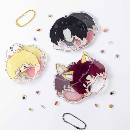 Three different cartoon characters are featured on the acrylic keychain shells, with food accessories and beaded cords scattered around them.