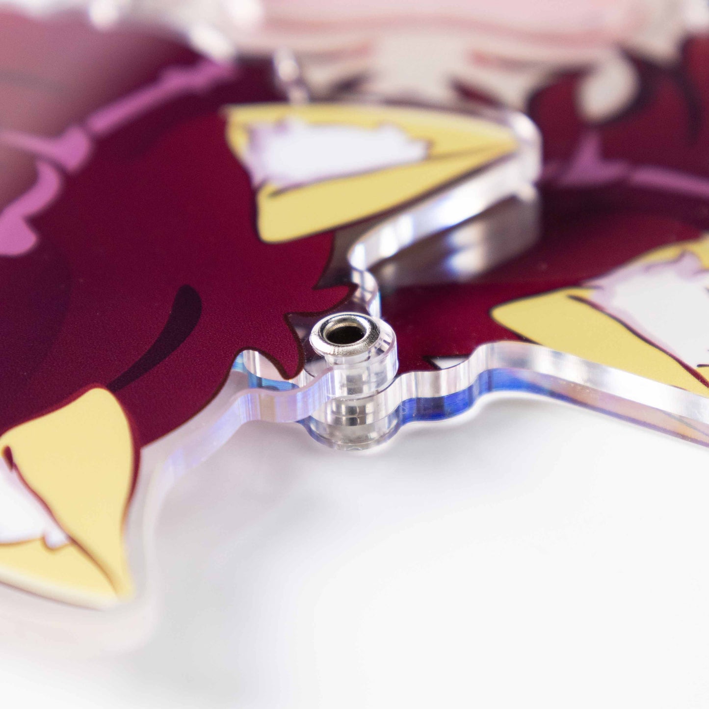 Close‑up of reinforced metal eyelet hole on custom acrylic shaker keychain
