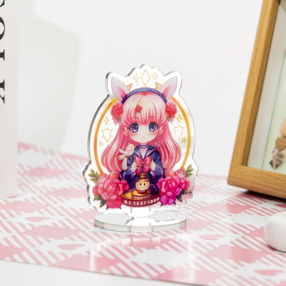 Custom acrylic mirror standees featuring anime characters, placed on a pink and white table as desktop decorations.