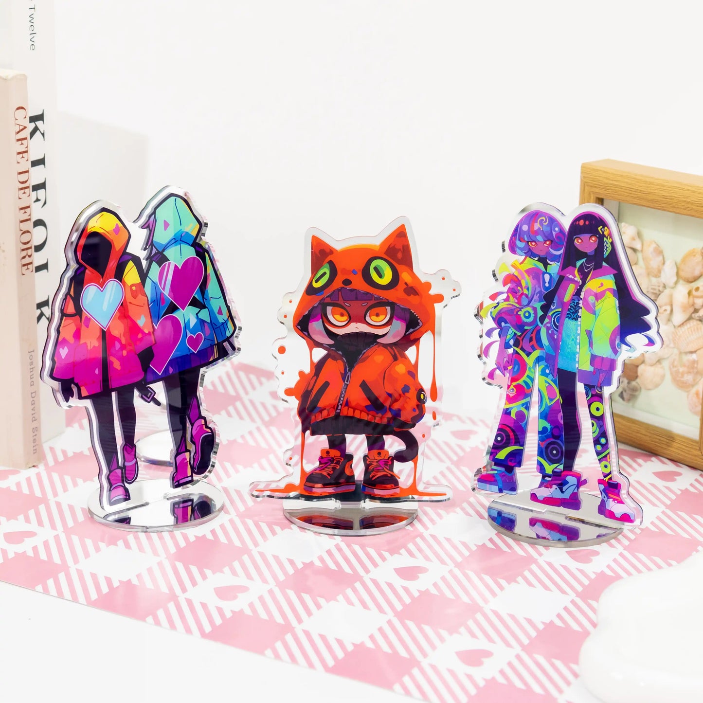 Assorted anime mirror acrylic standees set, multiple colorful character desk display stands on pink table